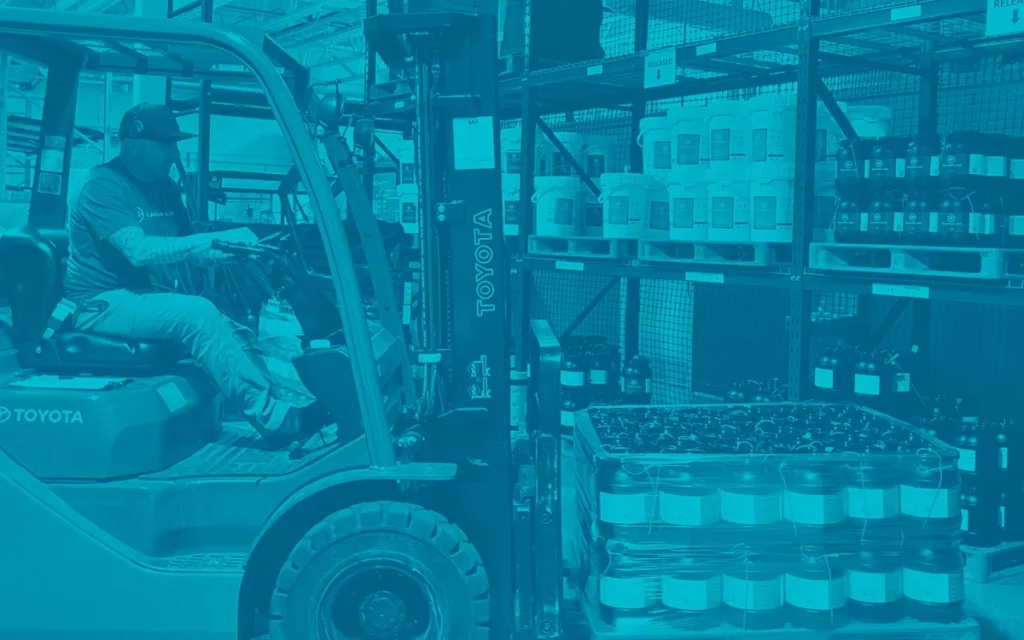 This is an image of a warehouse employee using a forklift to store CBD ingredients in a NSF registered facility.