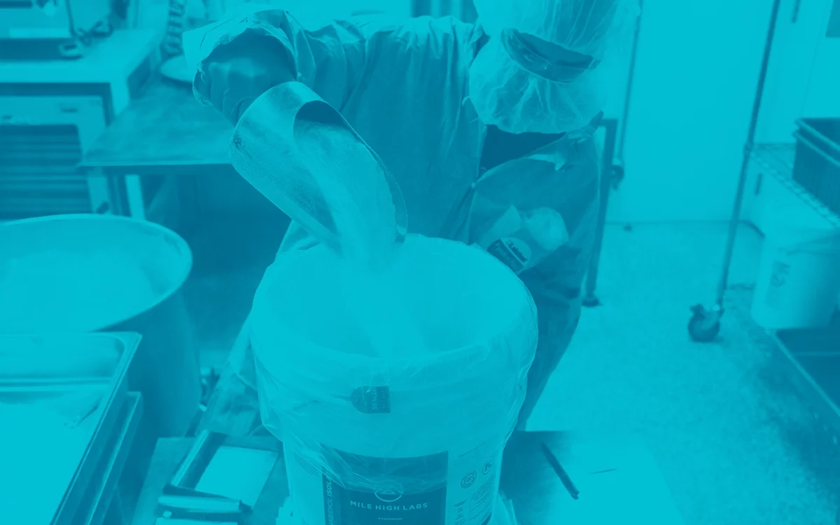 This is an image of a MHL operator pouring CBD Isolate into a container for distribution.